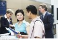 couple at airport ticket counter 42-16678082